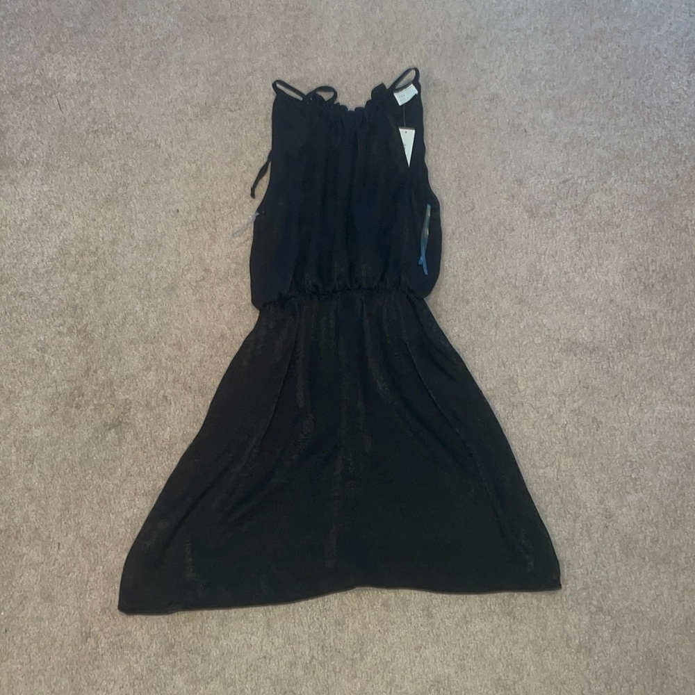 Black dress. Around knee-length.